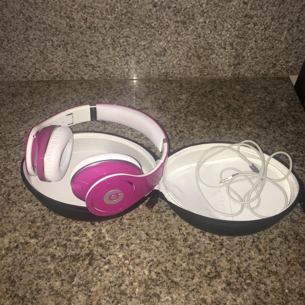 Hot pink Beats earphones.